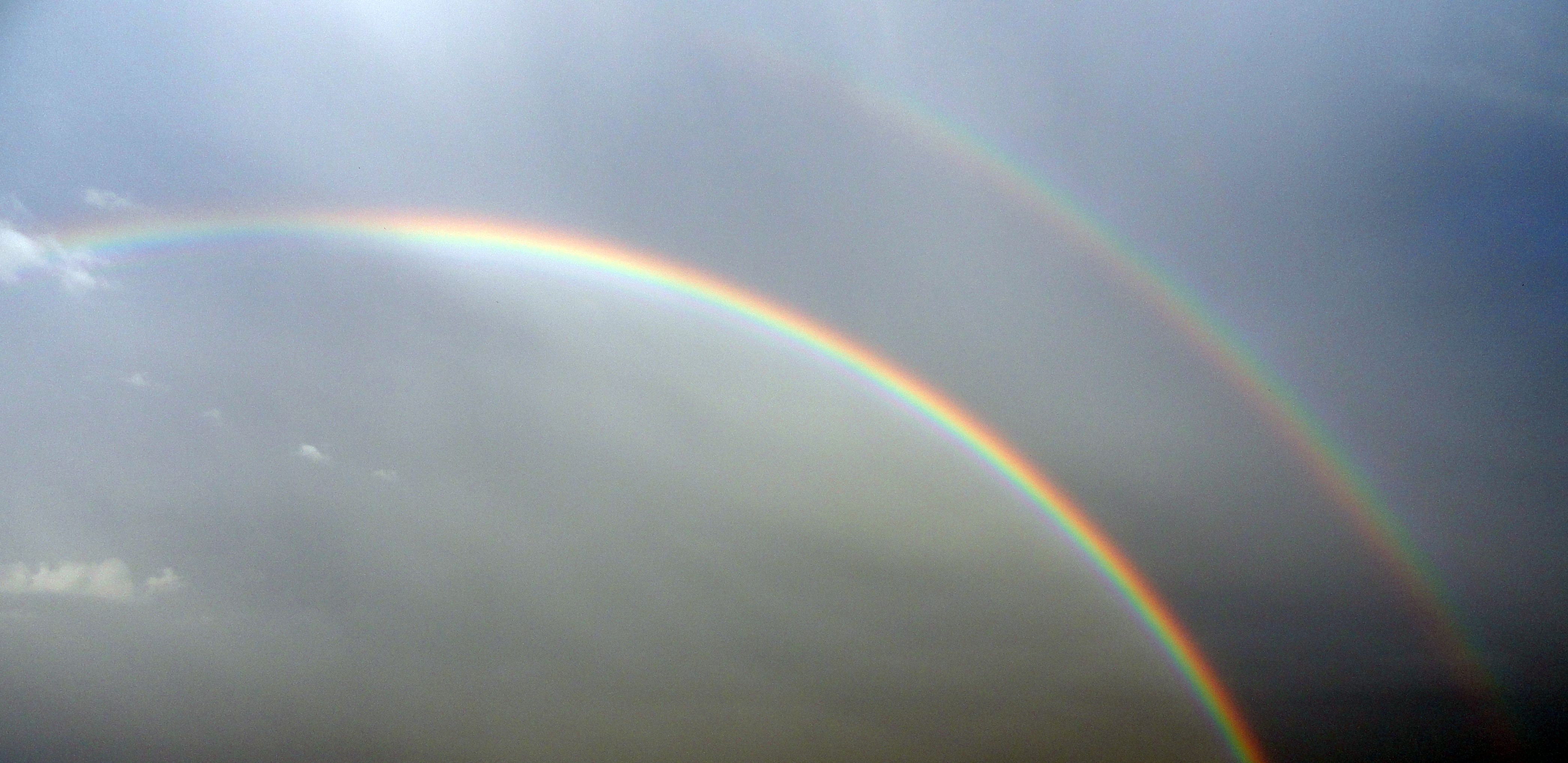 Double rainbow. The second rainbow results from a double reflection of sunlight inside the raindrops; the colours of this extra bow are in reverse order to the primary bow, and the unlit sky between the bows is called Alexander's band, after Alexander of Aphrodisias who first described it (Image: Wikimedia commons)